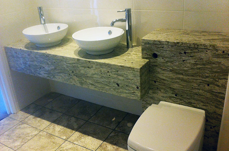 River White granite bathroom – Featuring vanity unit with twin sinks and concealed cistern River White granite bathroom